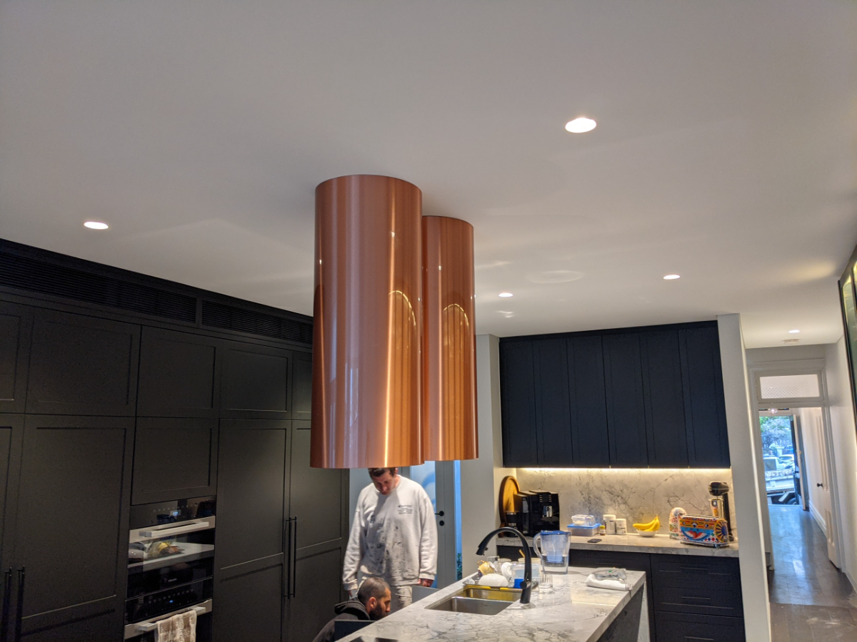 Designer kitchen with copper rangehood and recessed downlights, Sydney renovation