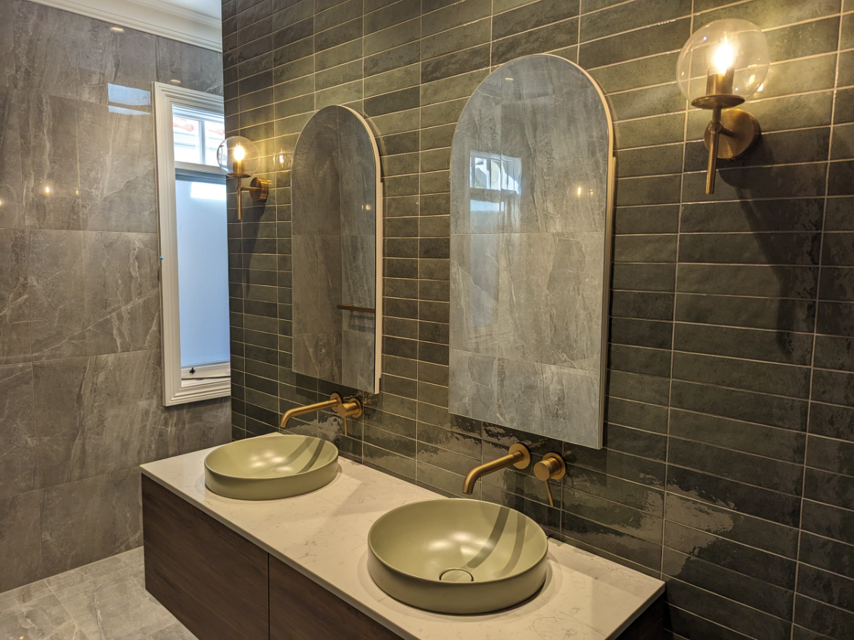 Modern bathroom with brass sconce lighting and feature tiling, Sydney metro