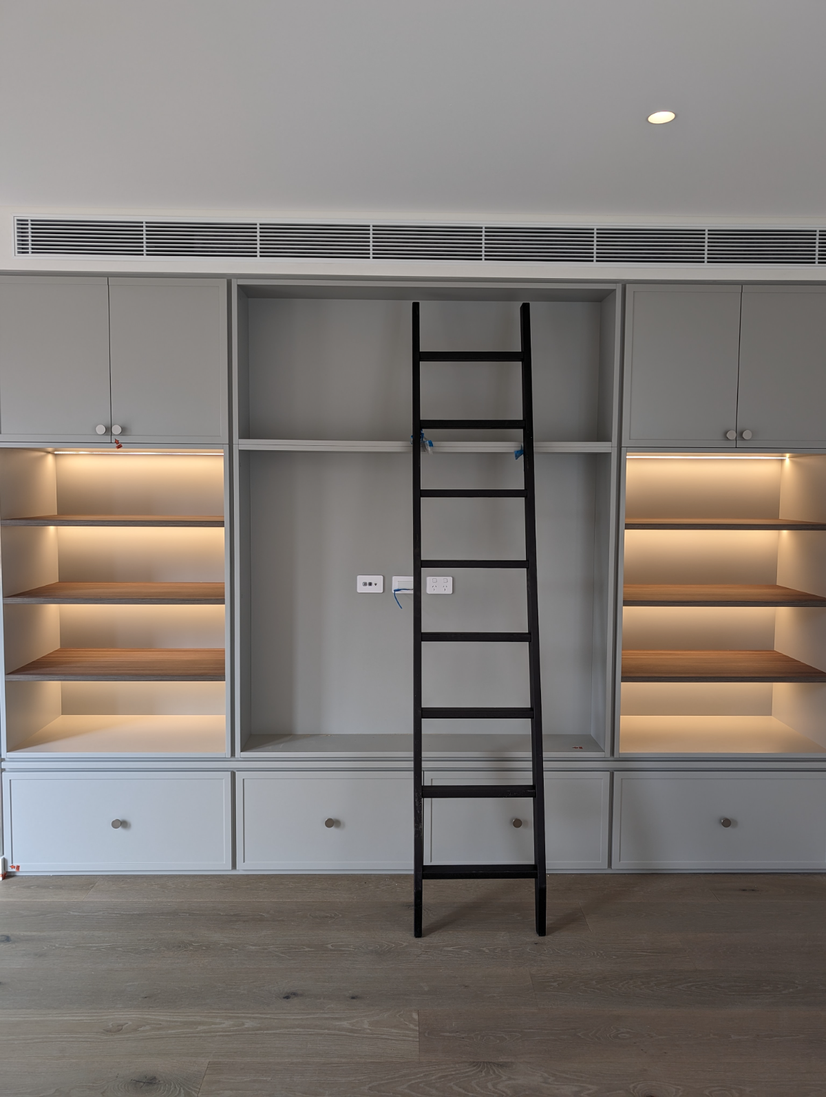 Built-in joinery with concealed LED shelf lighting, Sydney home