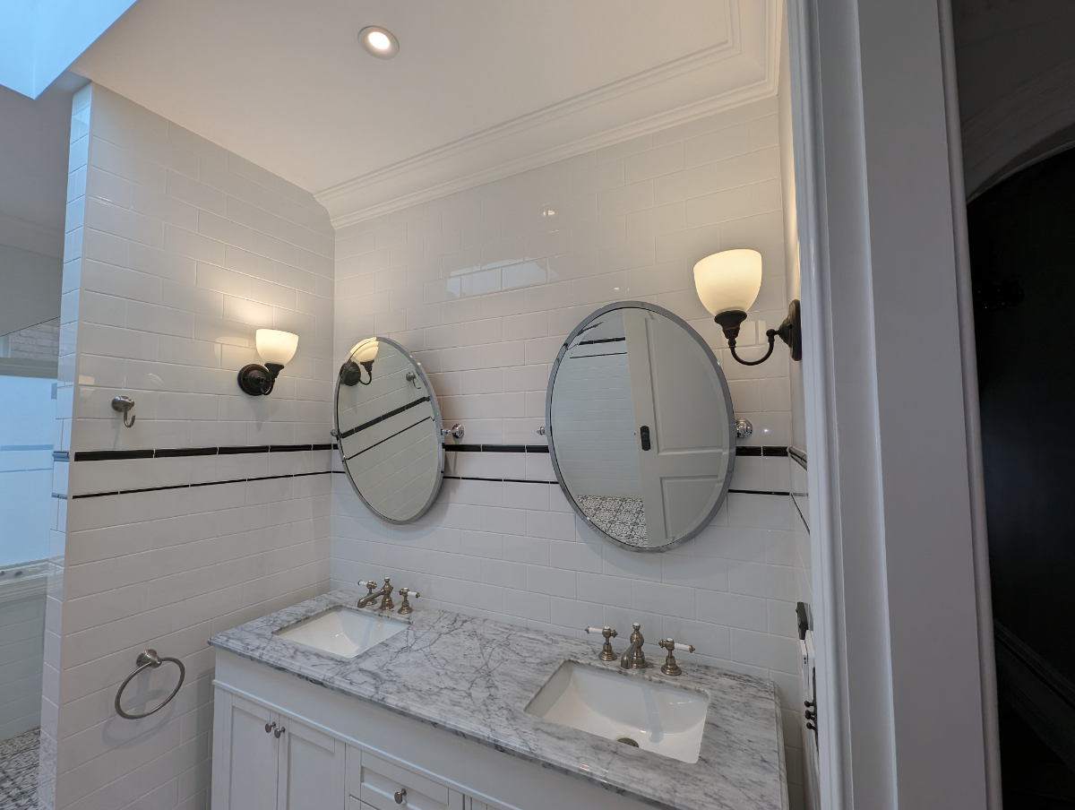 Heritage bathroom restoration with traditional wall sconces and marble vanity, Sydney