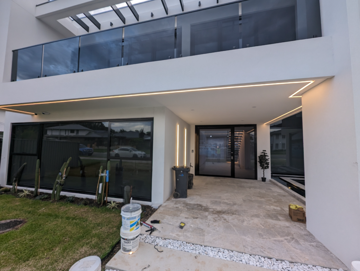 Modern home entry with linear LED strip lighting at dusk, Sydney